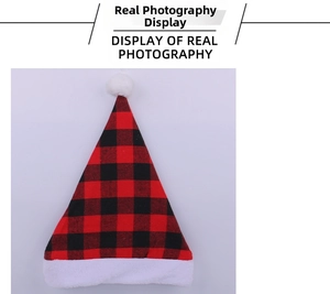 Detail of red and black plaid Christmas hat with soft white plush trim and pom-pom