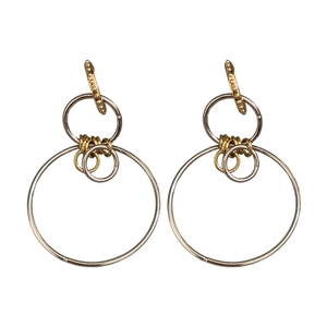 Minimalist geometric circular earrings featuring intertwined gold and silver metal rings