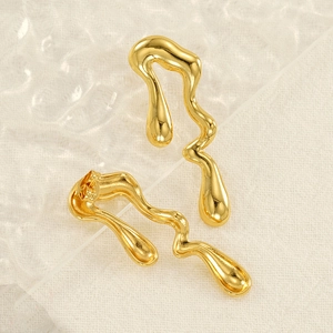 Macro shot of 18K gold-plated stainless steel teardrop earrings with fluid lava texture