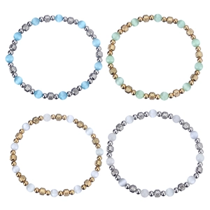 Detail showing elastic beaded bracelets with cat eye stones and engraved metal beads