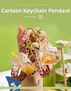 Detailed close-up of acrylic milk tea keychain with liquid sand and cute bear charms