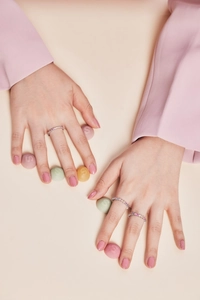 Detailed close-up of colorful zircon sterling silver ring worn by a fashion model