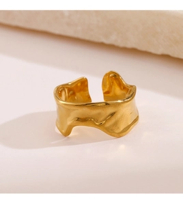 Detail view of gold irregular wavy ring with unique melted lava texture finish