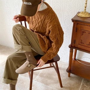 Close-up of brown winter socks with delicate flower embroidery and corduroy pants