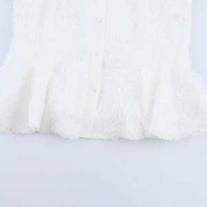 White camisole top featuring 3D rose floral texture, button front, and ruffled hemline
