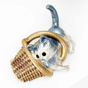 Detail of cute enamel cat in a golden woven basket brooch for women's sweaters