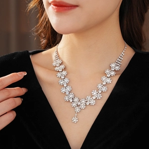 Exquisite silver necklace featuring a chain of sparkling diamond sunflowers on a model