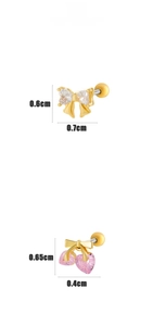 Detail view of gold bow earrings with clear and pink heart-shaped cubic zirconia studs