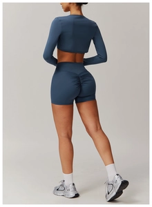 Detailed back view of dark blue yoga set featuring scrunch-butt shorts and cropped top