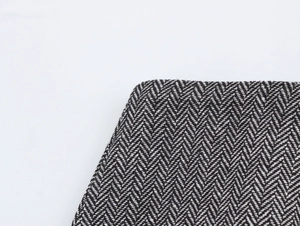 Close-up of elegant black and white herringbone tweed fabric with thick texture