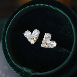 Elegant heart-shaped stud earrings with gold base, zircon stones, and small pearls