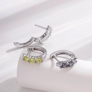 Silver huggie hoop earrings with colorful zircon stones shown from multiple angles