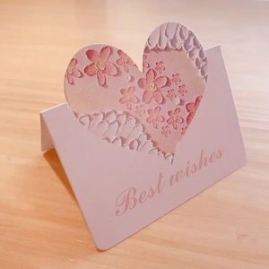 Close-up of pink 3D greeting card featuring a hollow heart and floral texture detail