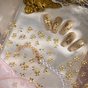 Elegant gold foil floral nail art stickers with vintage flower designs for manicures