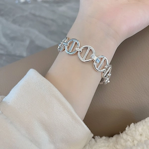 Close-up of silver pig-nose anchor chain bracelet on wrist with elegant metallic finish
