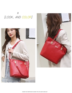 Detail view of a red quilted shoulder bag with gold chain strap on a model outfit