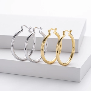 Polished S925 sterling silver hoop earrings in silver and gold finishes displayed on blocks