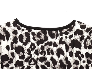 Detail of quilted leopard print vest showing high-quality stitching and round neckline