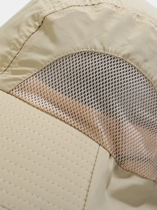 Detailed macro view of breathable mesh panel and reinforced stitching on sun hat