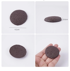 Macro detail of brown round cookie model charm showing natural porous texture and dimensions