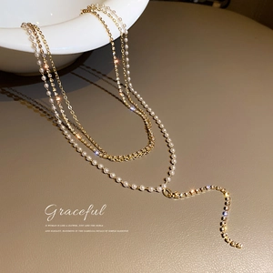 Elegant multi-layer gold Y-shaped necklace with pearls and sparkling rhinestones