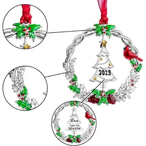 Christmas 2023 silver metal wreath ornament with red cardinal bird and holiday greeting
