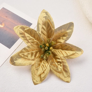 Macro shot of golden artificial Christmas flower with glitter texture for festive decor