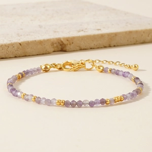 Bohemian style bracelet with purple natural faceted stone beads and golden metal accents