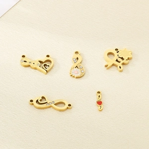 Detail of 18K gold stainless steel charms with heart, infinity symbols, and sunflowers