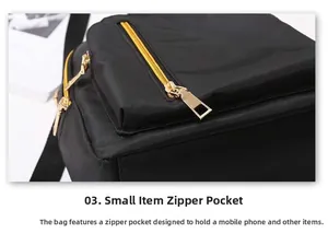 Close-up of front zipper pocket on black waterproof nylon backpack with gold hardware