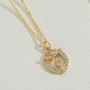 Macro shot of gold cross pendant with Jesus figure and sparkling cubic zirconia halo