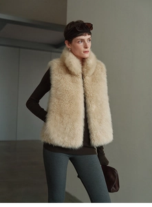 Detail of the thick beige faux fur texture on this sleeveless cashmere blend vest coat