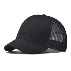 Close-up of black trucker hat showing breathable mesh back and solid canvas front