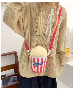 Close-up of cute popcorn bucket shaped crossbody bag with red and white stripes