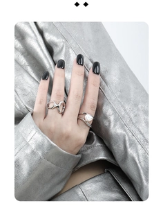 Close-up of a model wearing a S925 silver irregular hollow round ring and a pearl ring
