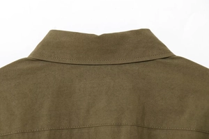 Detail of lapel collar and fine stitching on brown-green suede shirt set for women
