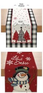 Detail of Christmas table runner with Merry Christmas and Let it Snow festive patterns