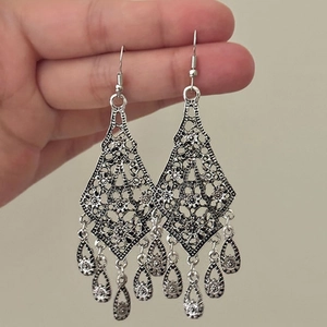 Silver hollow flower teardrop tassel earrings with vintage ethnic relief pattern