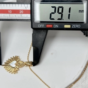 Close-up of heart shell pendant measured with digital caliper showing 29.1mm width