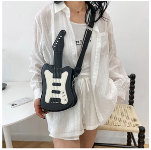 Close-up of guitar-shaped crossbody bag with star rivets and striped fabric strap