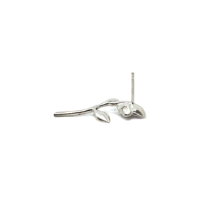 Macro shot of silver metal flower stem and leaf earrings with matte finish details