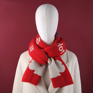 Detail view of red Christmas snowman knit scarf with white snowflake patterns