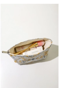 Detail of vintage floral embroidery canvas pouch showing large capacity for cosmetics