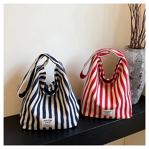 Detailed view of blue and red striped canvas tote bags with vintage brand label