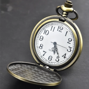 Classic vintage bronze quartz pocket watch with embossed flower cover on stone background