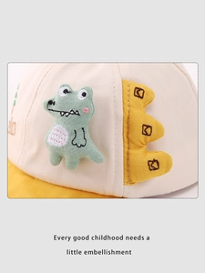 Close-up of cartoon dinosaur embroidery on cotton baseball cap for babies