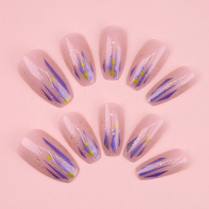 Macro view of purple geometric star nails with gold glitter on pink background