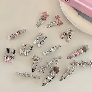 Detailed flat lay of pink rhinestone hairpins in heart and star shapes on silver alloy