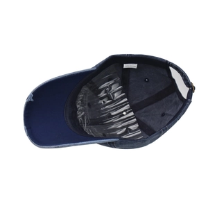 Detail view of cotton baseball cap interior showing sweatband and adjustable metal buckle