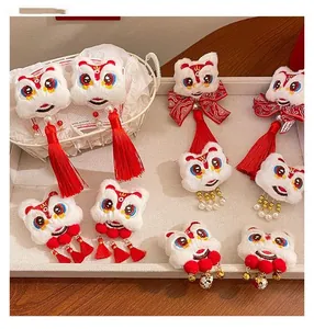 Close-up of Chinese New Year lion dance hair clips with plush fur, bells and red tassels